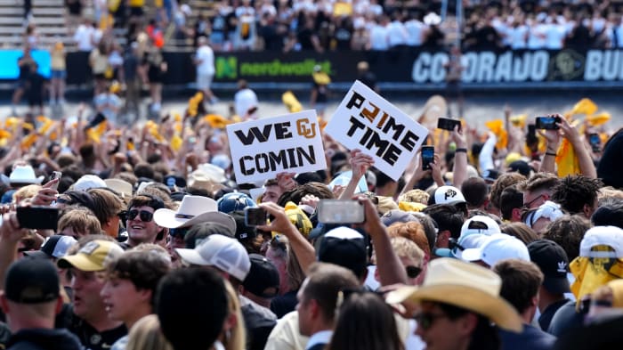 Colorado fans storm the field after the Buffaloes’ win over Nebraska.